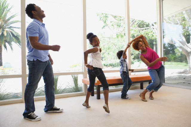 Family dancing together --- Image by © Blue Images/Corbis